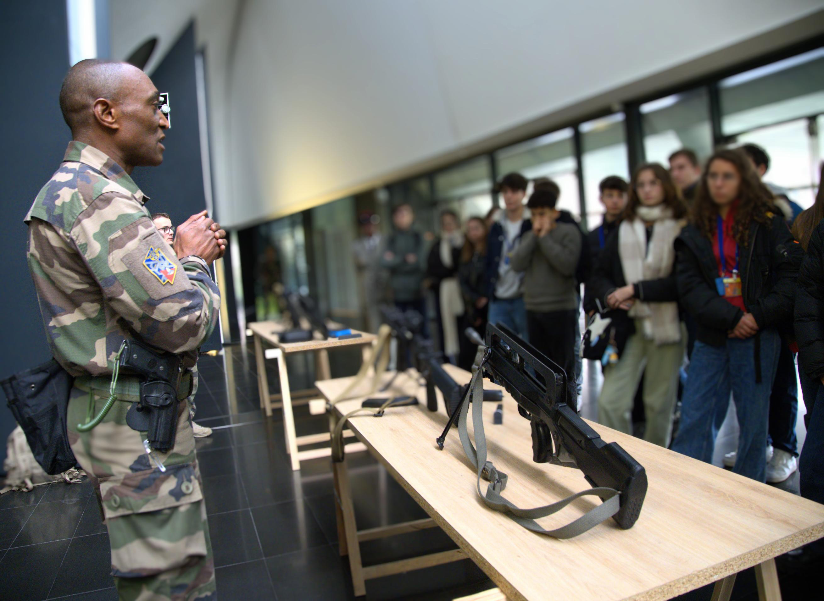 Un instructeur présente l'armement de l'armée de Terre aux élèves d'un lycée parisien.